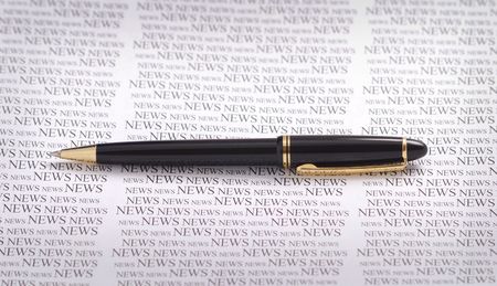 smart pen on news patterned  backgound. の写真素材
