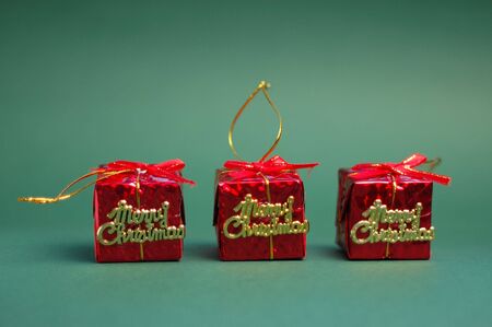 Red gifts on green background. Christmas decoration.の写真素材