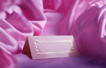 wedding invitation card on pink silkの写真素材