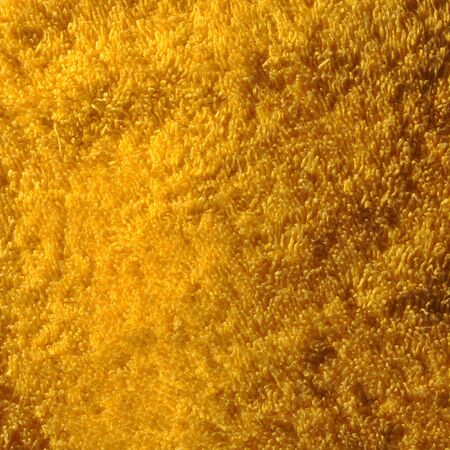 yellow terry cloth towel textureの写真素材