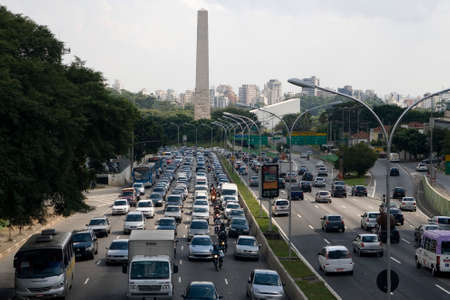 traffic in sao paulo, brazil, obelisk in backgroundのeditorial素材