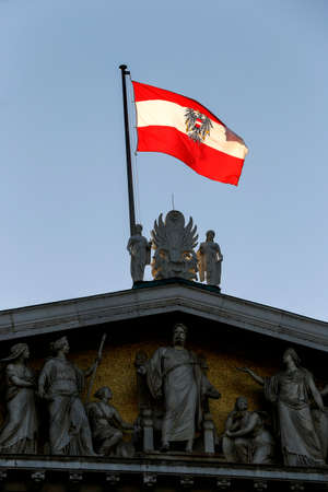 Austrian flag waving in the blue cloudless skyのeditorial素材