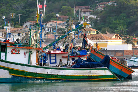 Santa Catarina, Brazil - aug 18 - 2005 - mens working  in fishing boat floating on the water on coast of Santa Catarina state in Brazilのeditorial素材