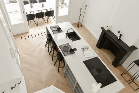 Minimalistic kitchen with a door leading to the outside open-air dining space with table and chairs