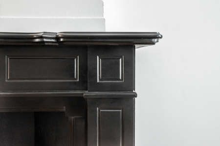 close-up of black fireplace in a room with white wallsの写真素材