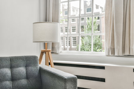 View of bright living room with sofa and lamp by the windowの写真素材