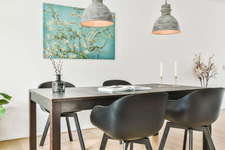 Bright dining room with decorative table and chairs made in a luxury style. Elegance interior of a modern houseの写真素材