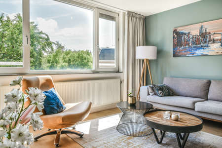 Living room with carpet, mild sofa, table, and other luxury furnitureの写真素材