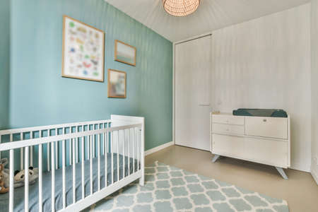 Modern childrens room with bed and brightly decorated wallsの写真素材