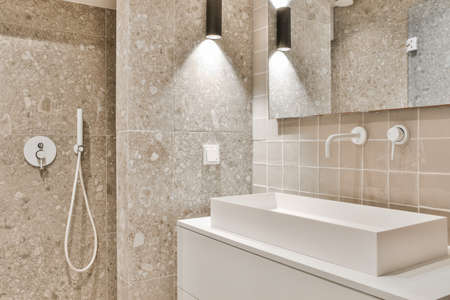 Bright elegant bathroom interior with marble wallsの写真素材
