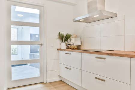 Bright kitchen with luxury kitchen island in elegant houseの写真素材