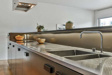 Bright kitchen with luxury kitchen island in elegant houseの写真素材