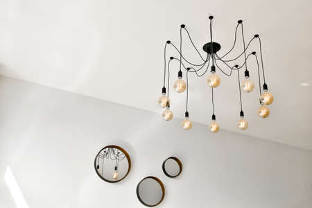 Beautiful chandelier on a ceiling and mirrorsの写真素材