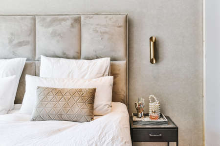 Minimal style interior of bedroom with soft bed and cushions in modern apartmentの写真素材