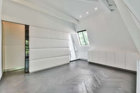 Interior of spacious room in modern cottage with white walls designed in minimal style