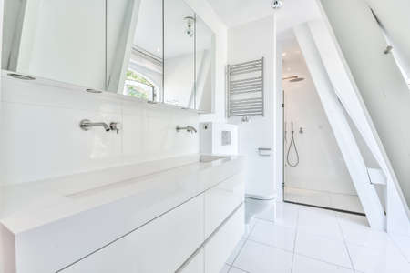 Interior of contemporary bathroom with white ceramic sink and shower in minimal styleの写真素材