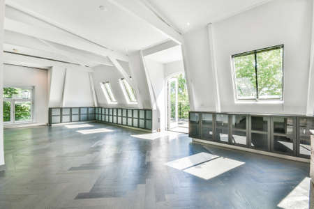 Interior of empty spacious room with white walls in cottage designed in minimal styleの写真素材