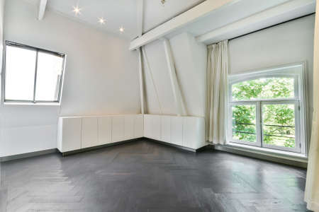 Interior of spacious empty room with white walls and geometric elements in contemporary cottage in minimal styleの写真素材