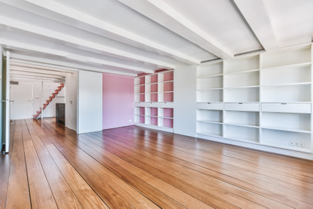 Interior of spacious room with empty shelves and wooden floor in modern apartmentの写真素材