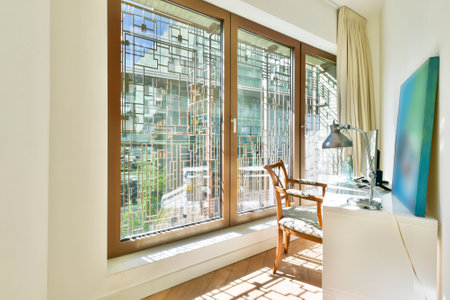 Cozy terrace of apartment with wood flooring and white cushions on bench aside small table