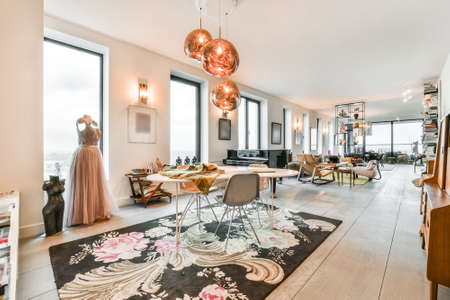 Spacious room with table and chairs and pictures on the wall full of accessories
