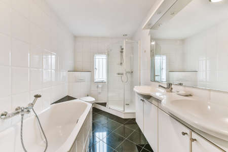 Beautiful bathroom with a big bathtub and white walls