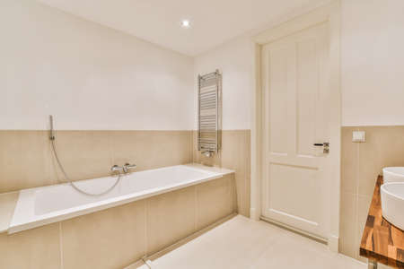Beautiful bathroom with a big bathtub and white walls