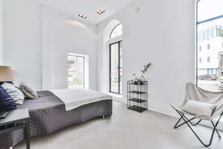 Interior of a cozy and bright bedroom with beautiful decorationの写真素材