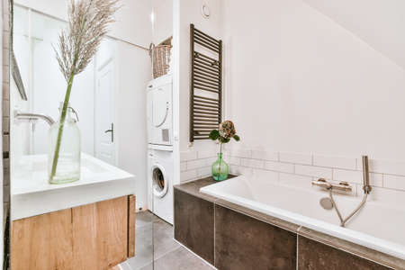 Beautiful bathroom with a big bathtub and white walls