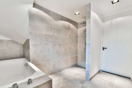 Beautiful bathroom with a big bathtub and white big windows