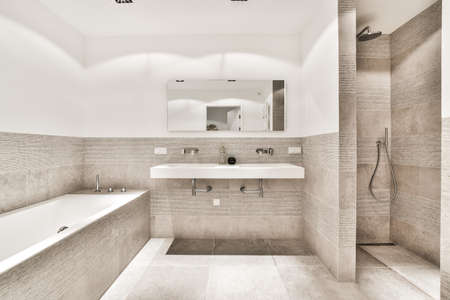 Beautiful bathroom with a big bathtub and white big windows
