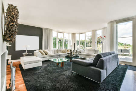 Interior of bright living room with stylish furniture