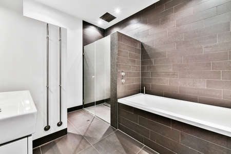 Beautiful bathroom with a big bathtub and marble walls