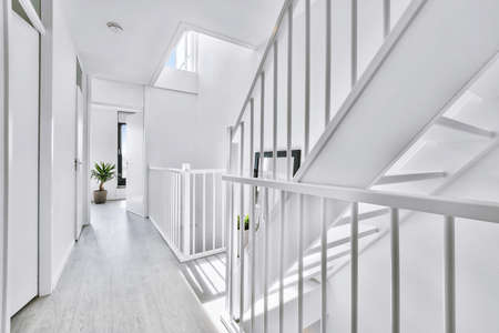 Designed in a minimalistic style staircase hall. Interior of luxury house stairsの写真素材