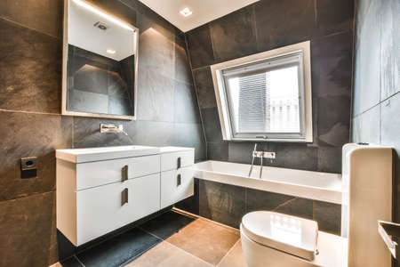 Bright and stylish bathroom with luxury bathtubの写真素材