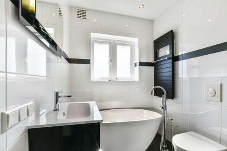 Bright and stylish bathroom with luxury bathtubの写真素材
