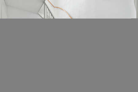 Designed in a minimalistic style staircase hall. Interior of luxury house stairsの写真素材