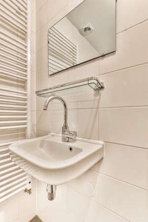 Beautiful bathroom with a faucet and white wallsの写真素材