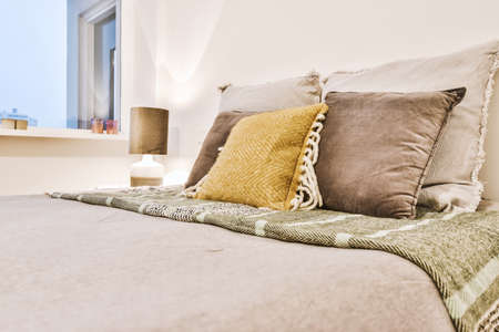 Stylish decor of the bed with decorative pillows