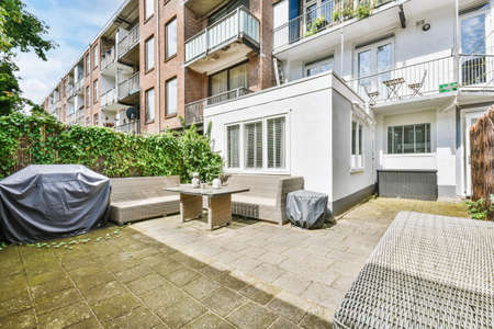 Trendy courtyard with cozy big sofa with building in the backgroundの写真素材