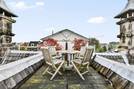 A very beautiful place with greenery on the roof with wooden table and chairs