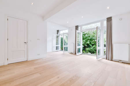 Big room with open doors leading to garden