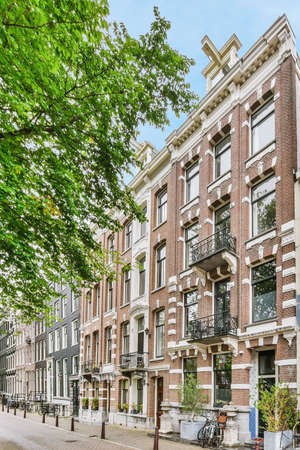 Luxury brick four-storey building exterior on a beautiful street
