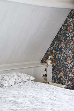 Corner of the bedroom with a chest and a lampの写真素材