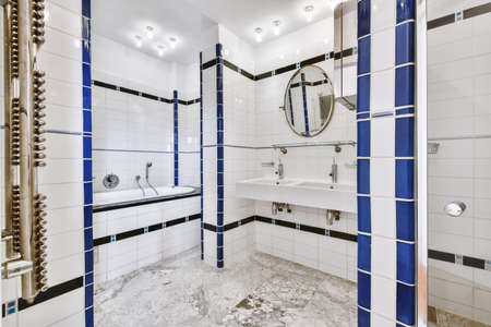 Stylish bathroom interior with white and blue marble on the walls
