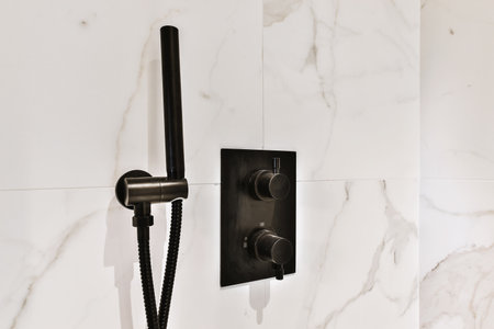 Close up of black water regulator in stylish bathroom