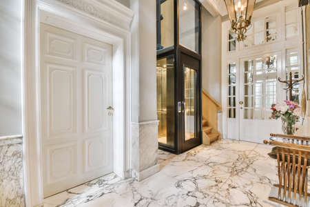 Elegant entrance hall with black glass liftの写真素材