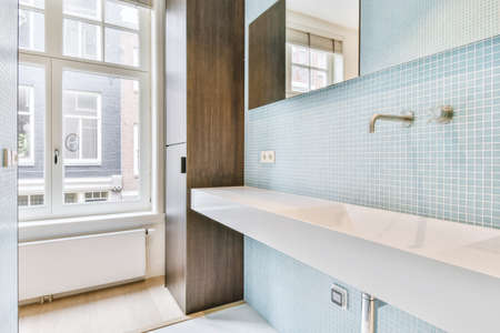 Bathroom with a long sink and mirrorの写真素材