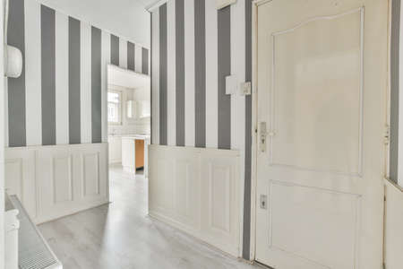 Corridor of a modern apartment with black white striped wallpaperの写真素材