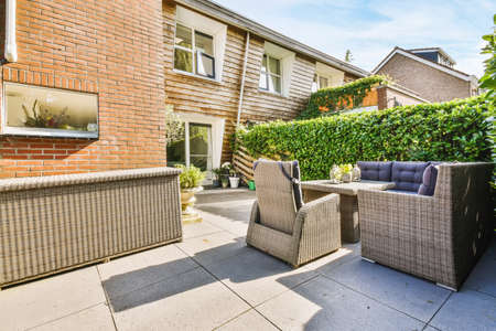 Courtyard of a stylish home with wicker benches